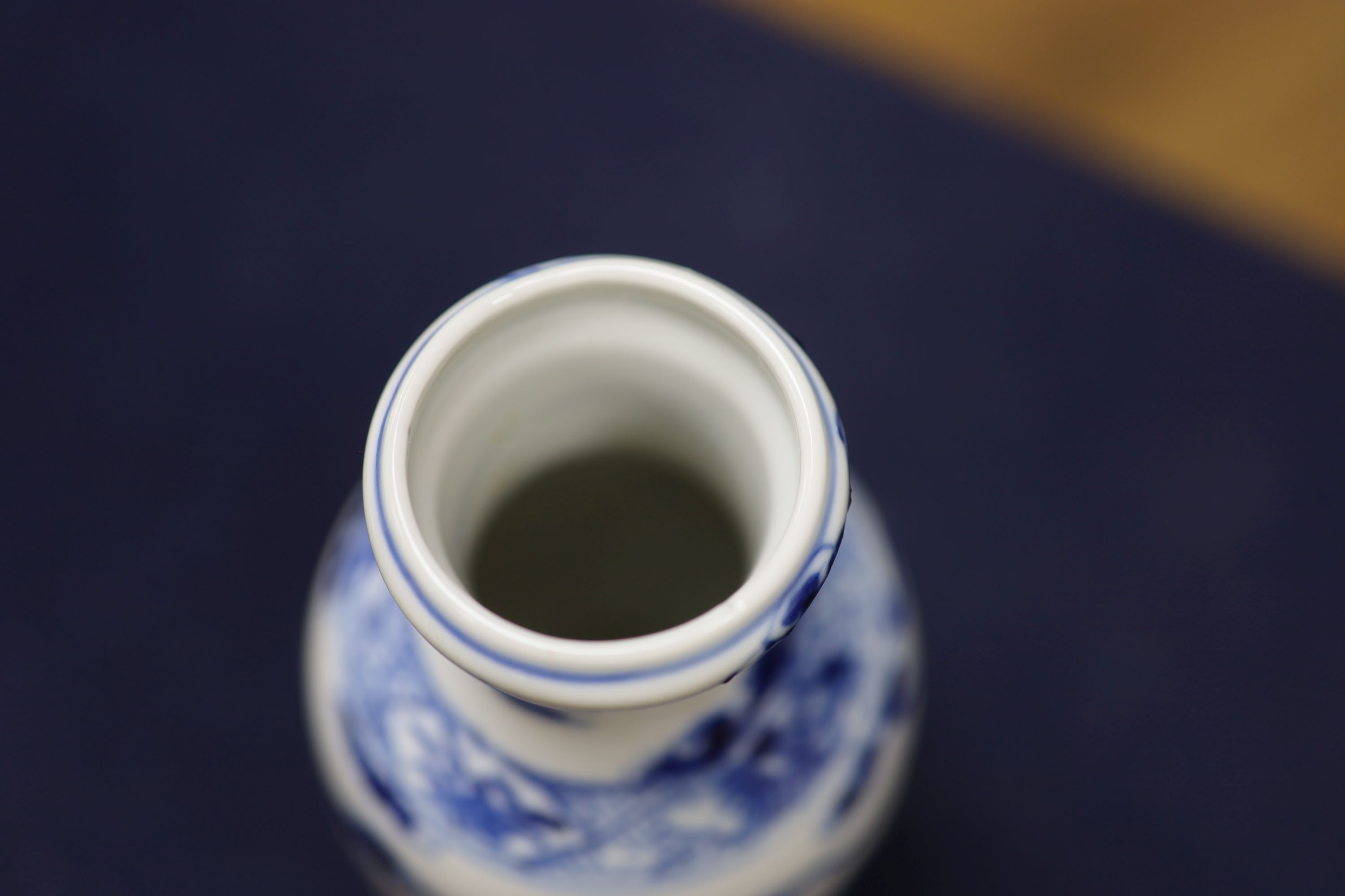 Two Chinese blue and white vases and a dish, together with a famille rose dish, tallest 28cm